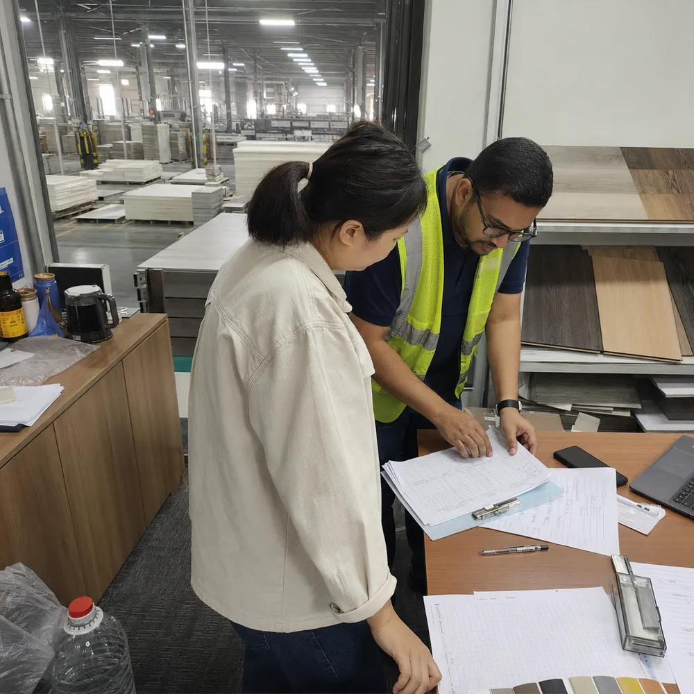 Third-party auditor reviewing production records and QC documentation at Elefloor factory