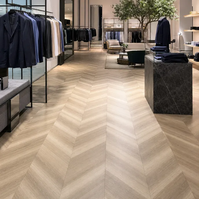 Chevron LVT flooring in a retail brand showroom environment