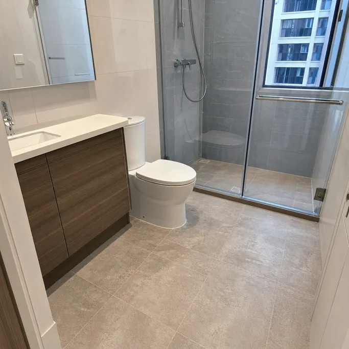 Tile-effect LVT flooring in a multi-unit apartment development bathroom