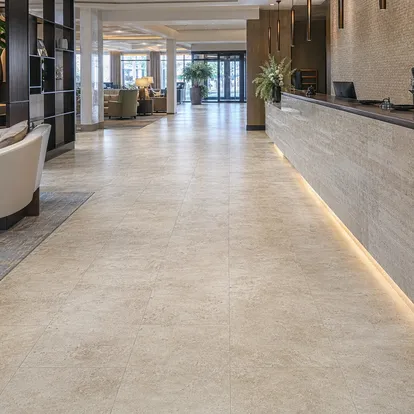 Tile-effect LVT in commercial hospitality lobby with travertine visual