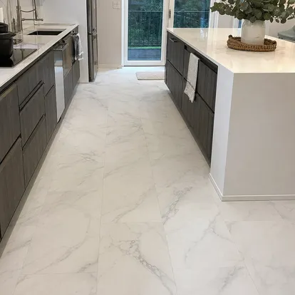 Tile-effect LVT installed in residential kitchen renovation with marble visual