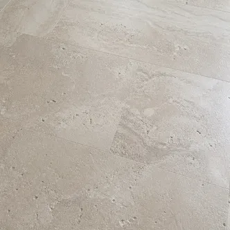 Travertine and limestone LVT tile with warm tones and natural pitting texture