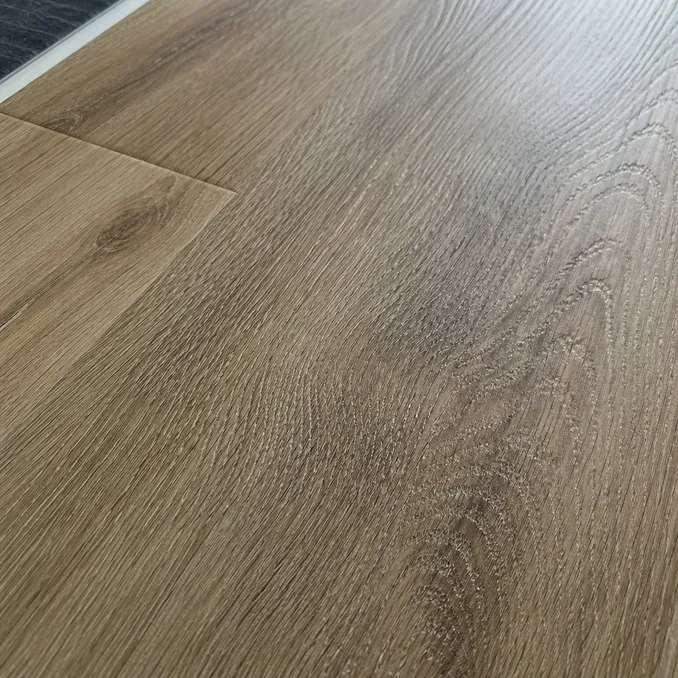 Close-up of embossed-in-register LVT surface showing grain alignment with printed wood pattern