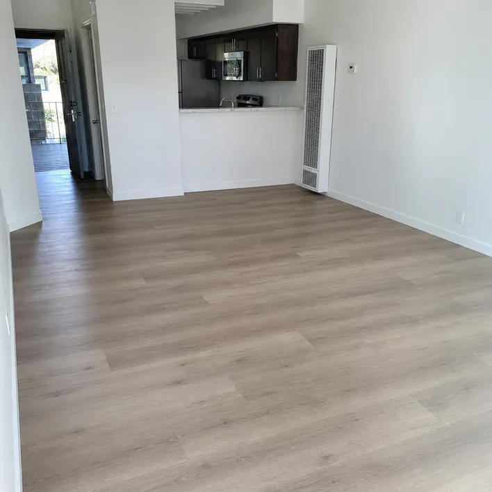 8mm SPC flooring in a multi-family rental unit showing durable finish and clean installation