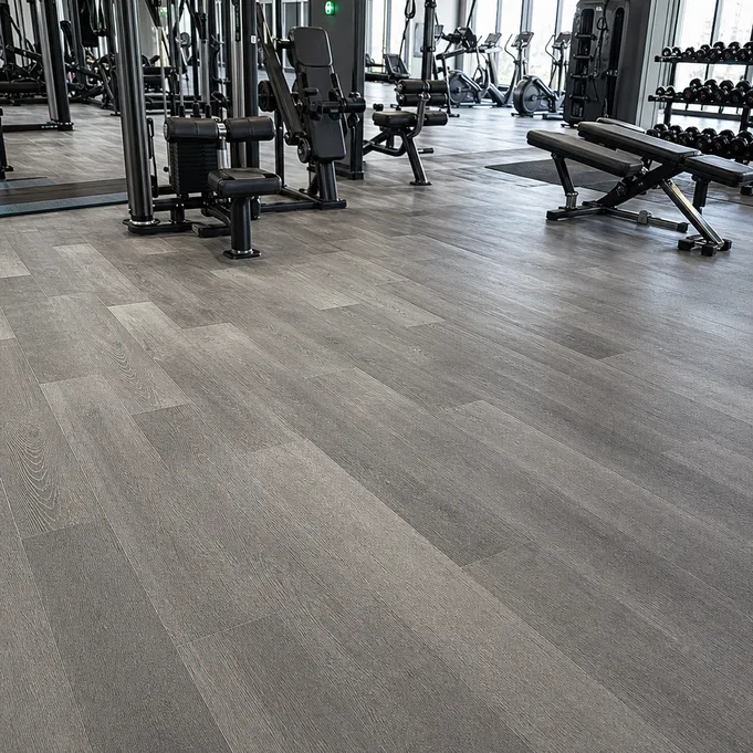 Gym SPC flooring installed in a commercial fitness center — rigid core click-lock planks with anti-slip surface texture