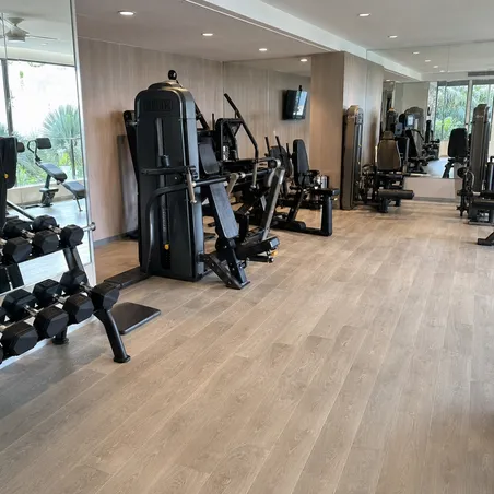 Hotel resort fitness center with SPC flooring matching hospitality interior design standards