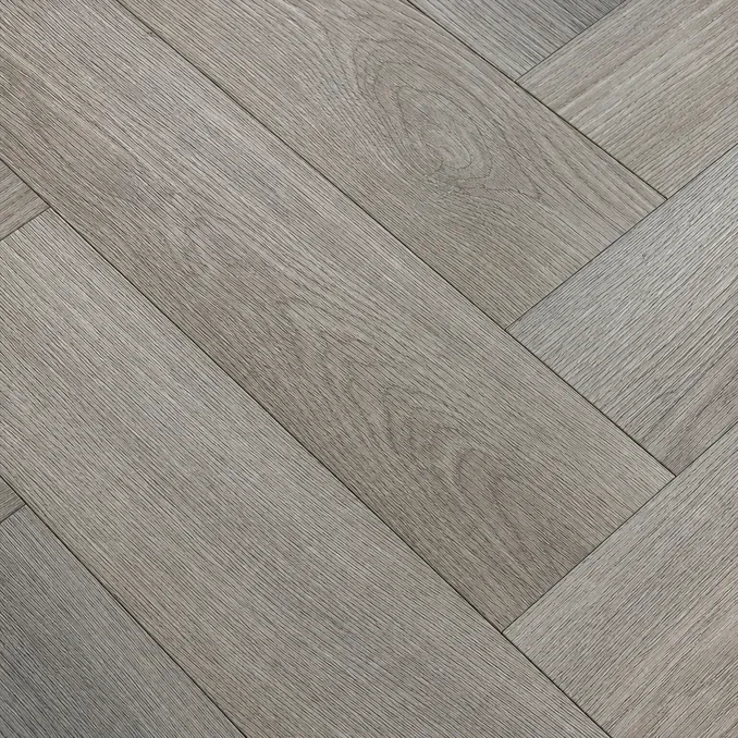 Close-up of EIR embossed-in-register surface texture on herringbone SPC flooring showing grain alignment