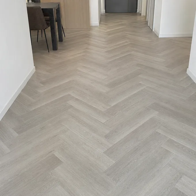 Herringbone SPC flooring pattern — precision click-lock planks installed in classic V-pattern