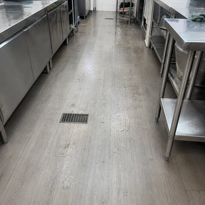 Kitchen SPC flooring installed in a commercial wet-area kitchen — R10 slip-rated surface with rigid core