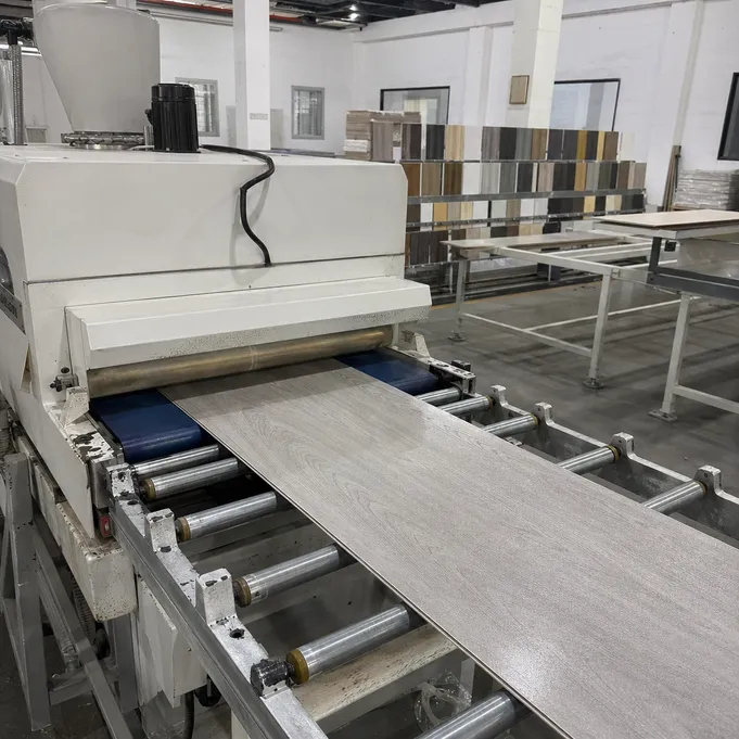 UV coating line applying ceramic micro-particle wet-area finish to kitchen SPC planks