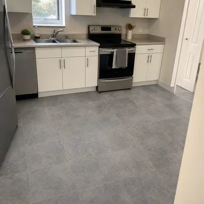 Multi-family rental kitchen with neutral grey stone SPC flooring