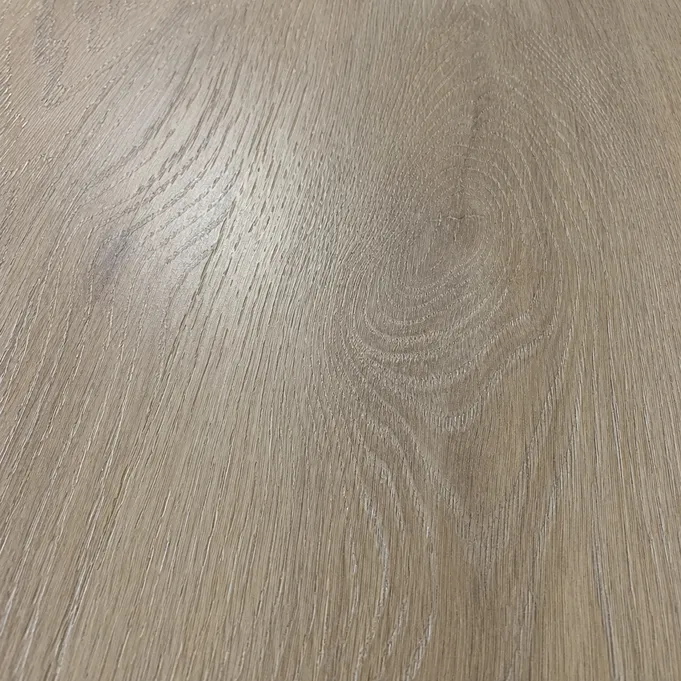 Close-up of embossed-in-register wood SPC flooring surface showing grain texture aligned to printed décor pattern